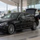 What Are the Best Ways To Travel from Toowoomba to Brisbane Airport? 2 Chauffeur loading luggage at airport curb