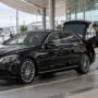 Chauffeur loading luggage at airport curb 90x90